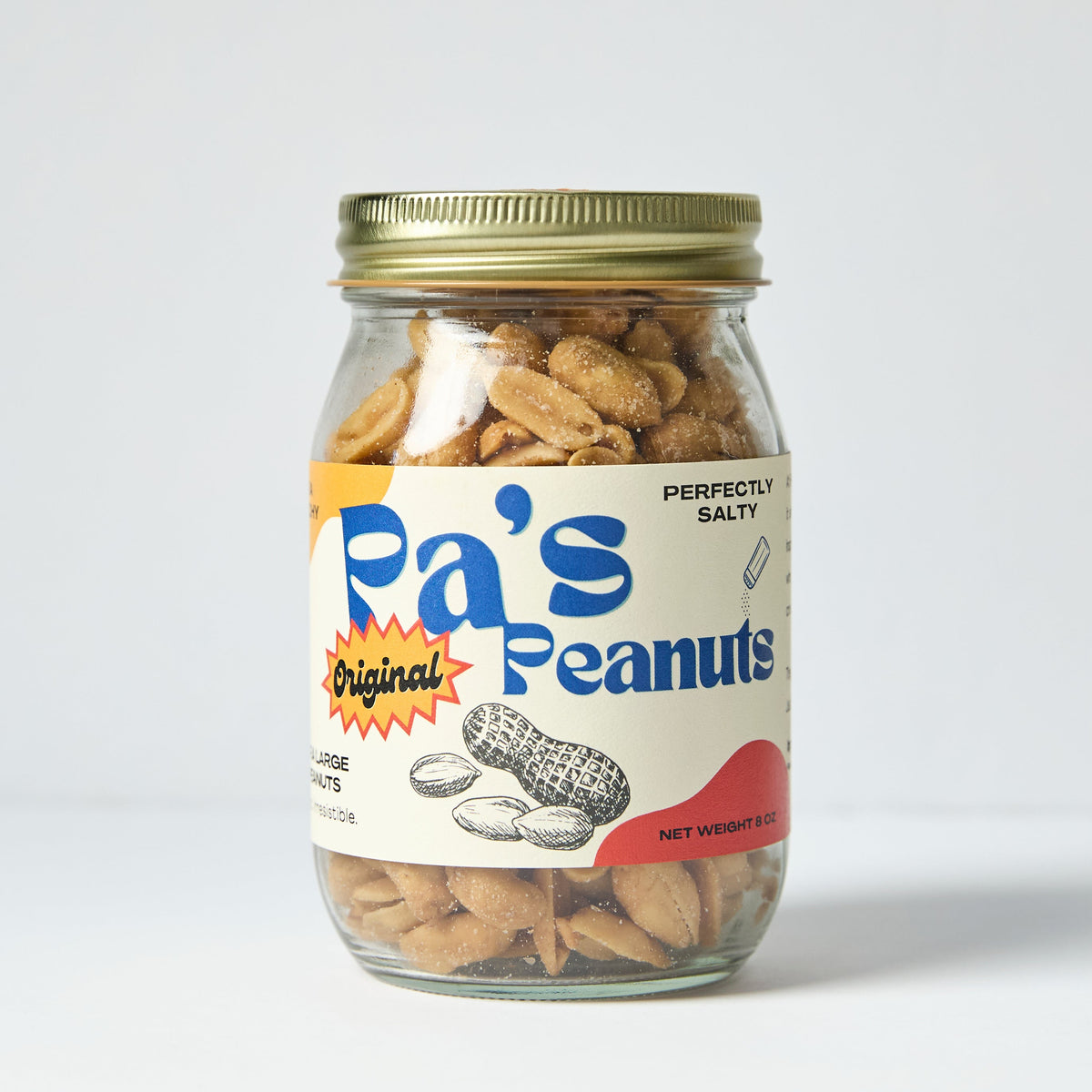 A jar of Pa's Peanuts with blue, red, and yellow colors on the label. The peanuts are toasty and crunchy looking!  You can see the salt on the peanuts. 